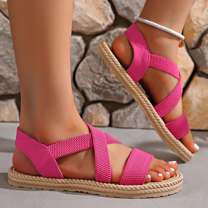 Adele woven sandals in multiple colors arranged together on a light surface