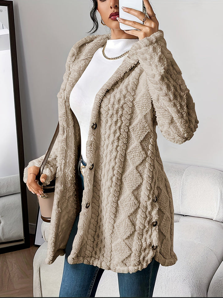 Lifestyle image of woman in a cozy plush hooded cardigan holding a warm drink on a cool morning