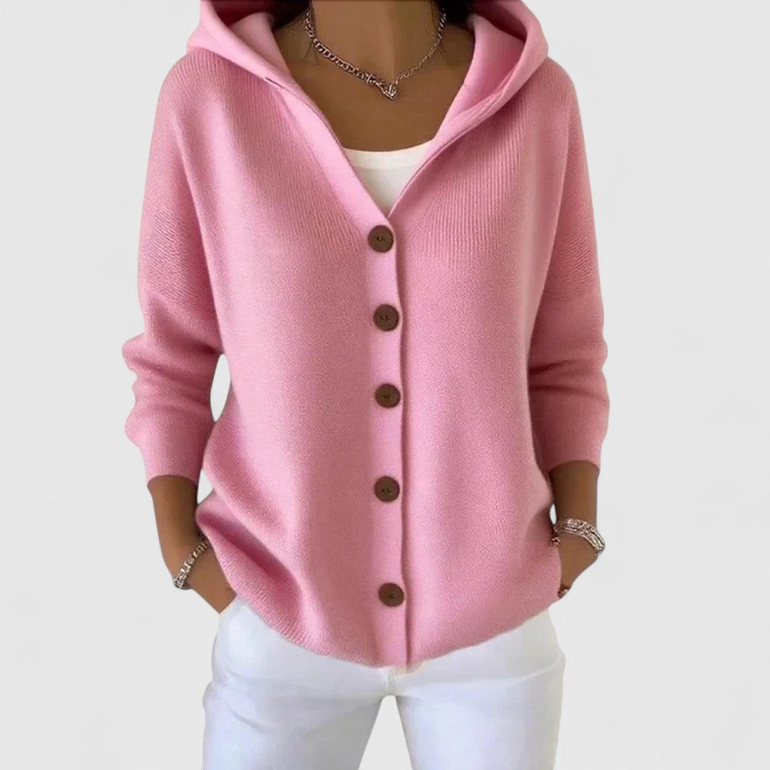 Woman wearing the Agnes elegant cardigan in a soft pastel color, styled as a chic layering piece over a simple outfit