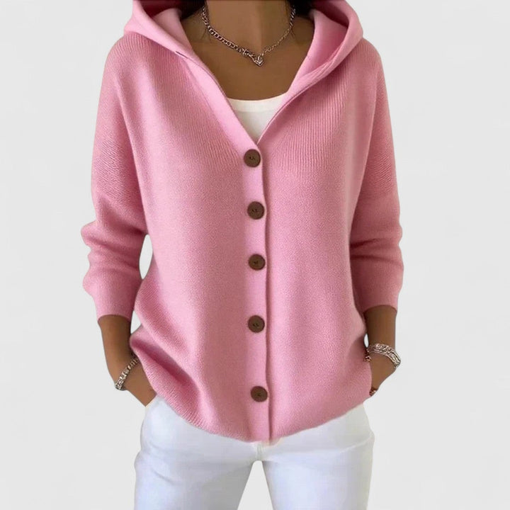 Woman wearing the Agnes elegant cardigan in a soft pastel color, styled as a chic layering piece over a simple outfit