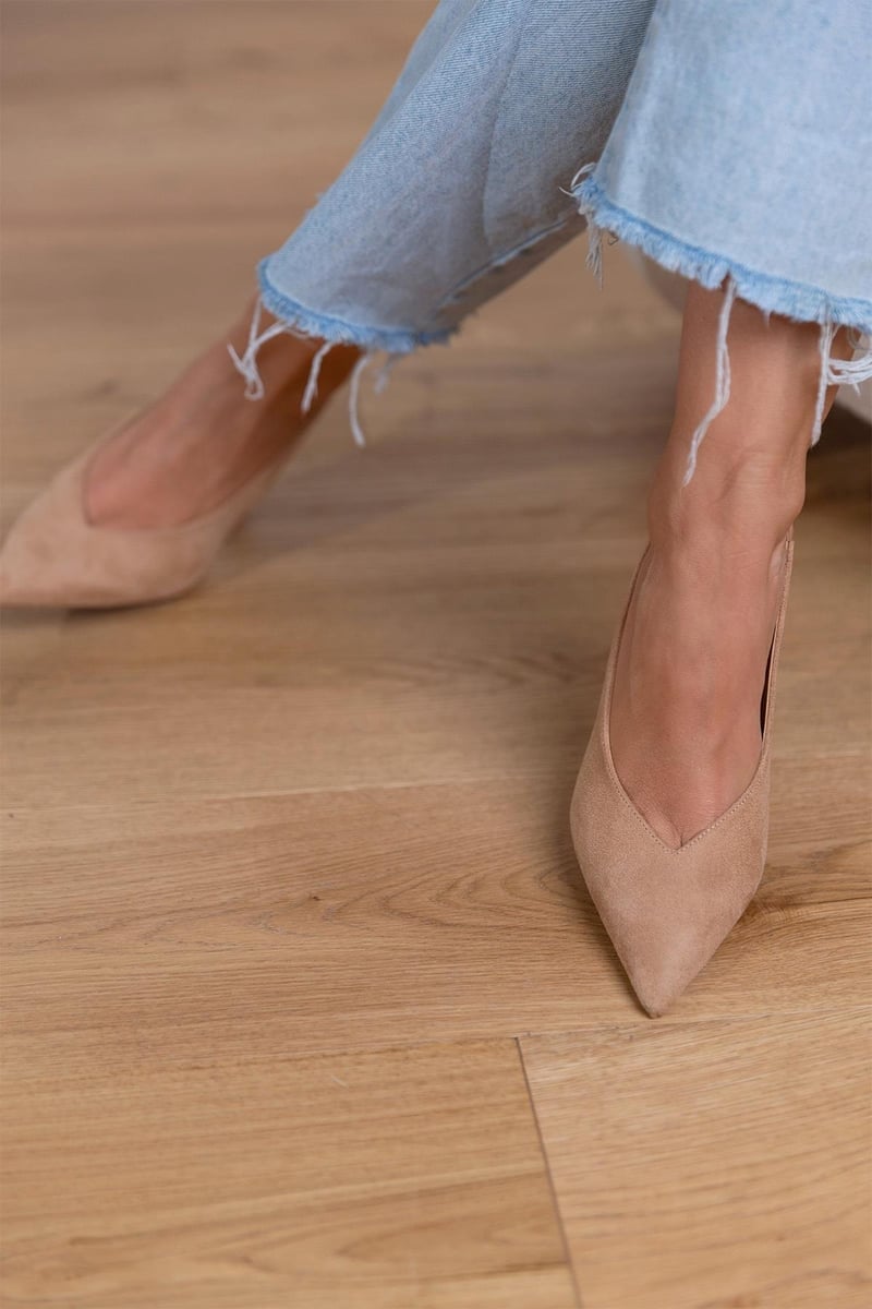 Ailani beige low heels styled in a flat-lay with neutral accessories and soft fabric
