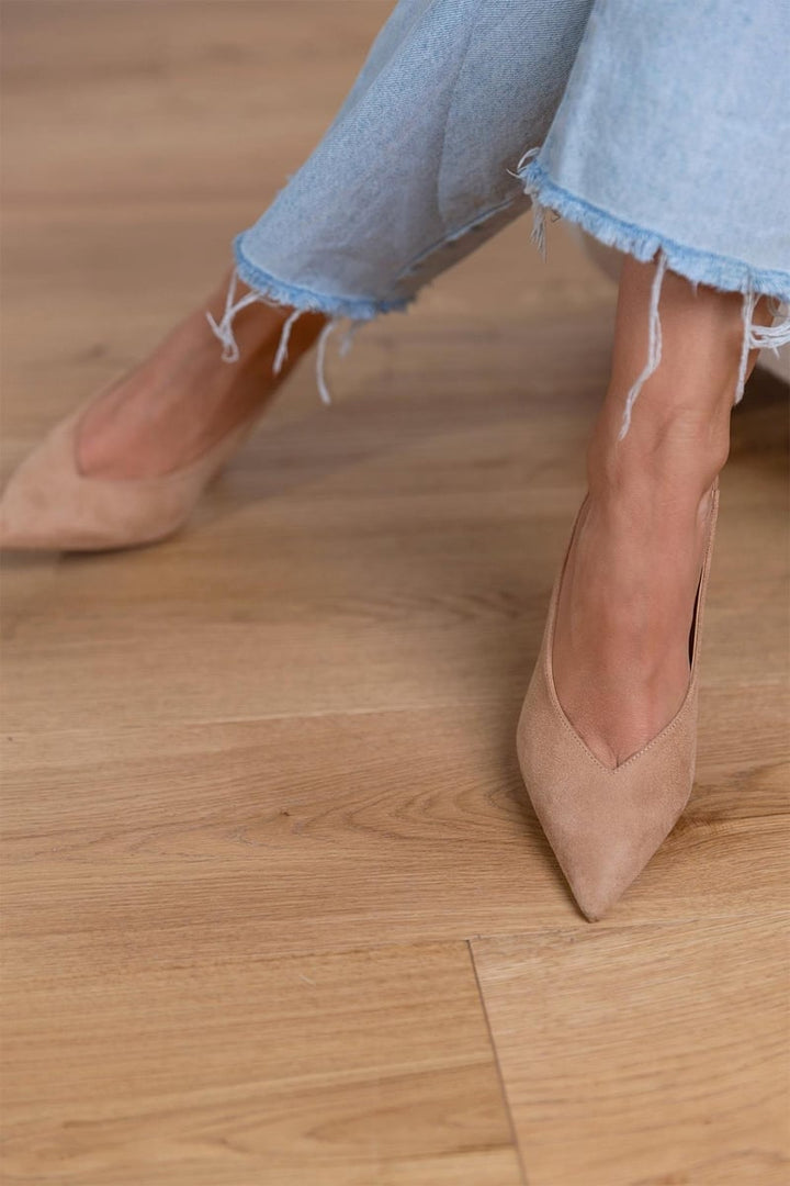 Ailani beige low heels styled in a flat-lay with neutral accessories and soft fabric