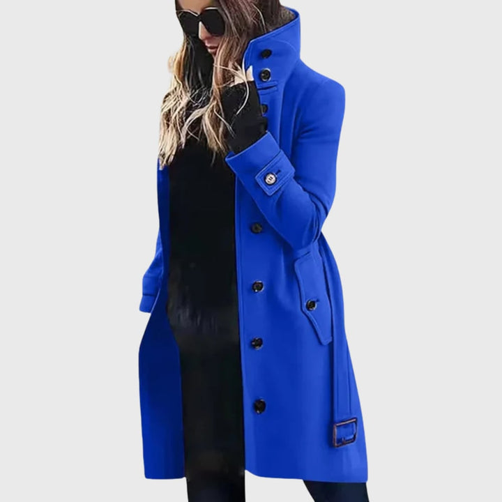 Model in a water-repellent long trench coat in green, showcasing the elongating longline design
