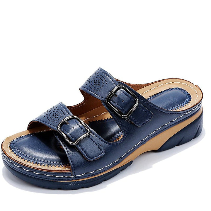 Lifestyle flat lay of Ainsley women's orthopedic sandals in multiple colors on neutral background