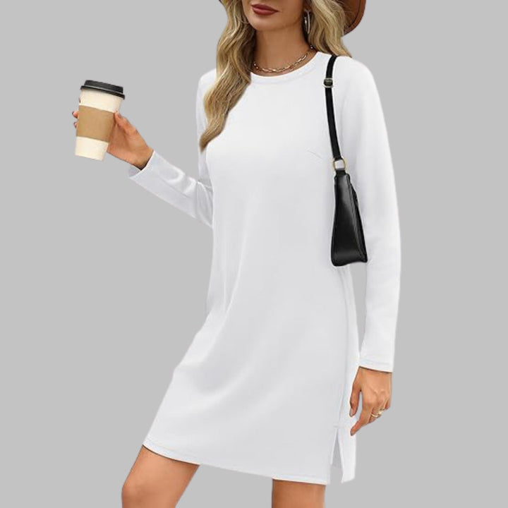 Woman wearing a white long sleeve round neck slim fit dress with a relaxed everyday look