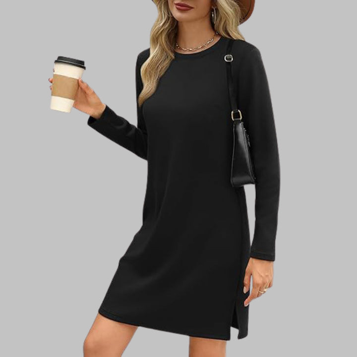 Woman in a black long sleeve round neck dress styled casually for an everyday outfit
