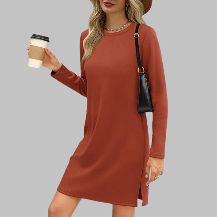 Claret long sleeve round neck dress worn by a woman in a simple stylish pose