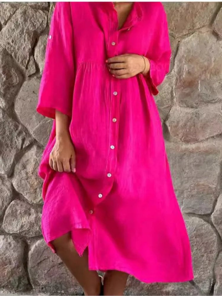 Woman wearing the Alba linen midi shirt dress in pink with full button-front closure and band collar