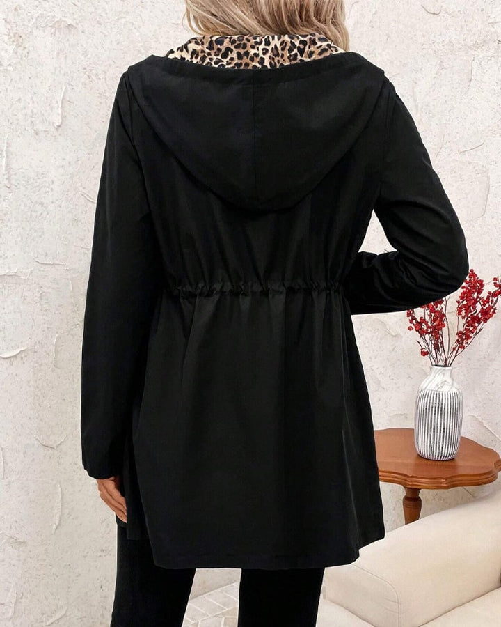 Full-length rear view of the Aleah reversible coat in black