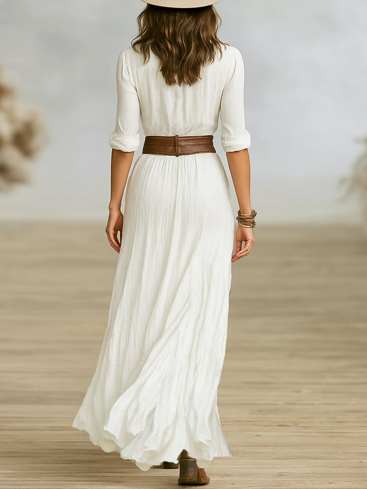 Side profile of the Alessandra chic maxi dress in brown highlighting the flowing skirt