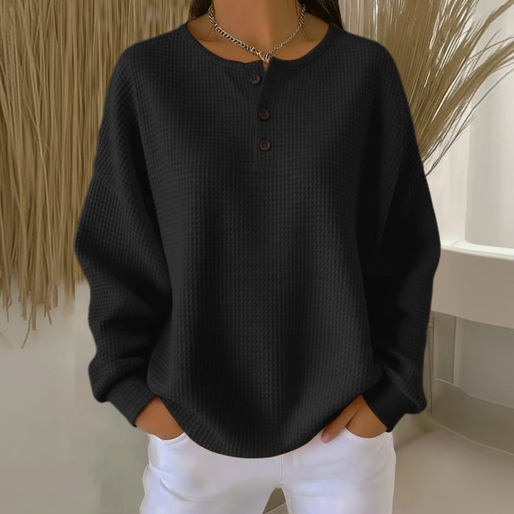 Model styling the Alexa cozy waffle sweater with high-waist jeans for a casual-chic look