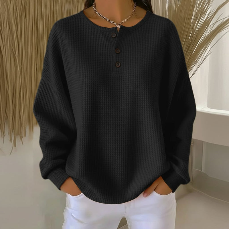 Model styling the Alexa cozy waffle sweater with high-waist jeans for a casual-chic look