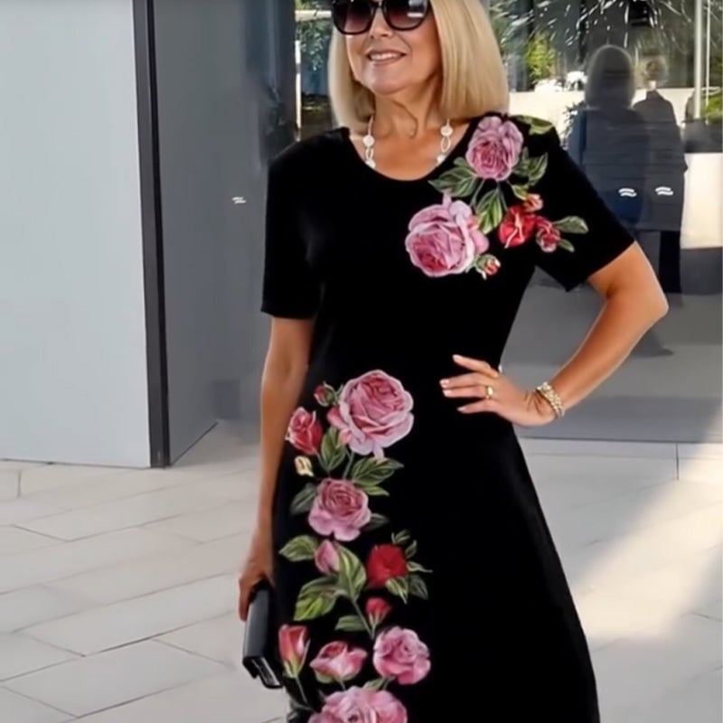 Full-length shot of a woman in a white floral A-line dress against a bright background