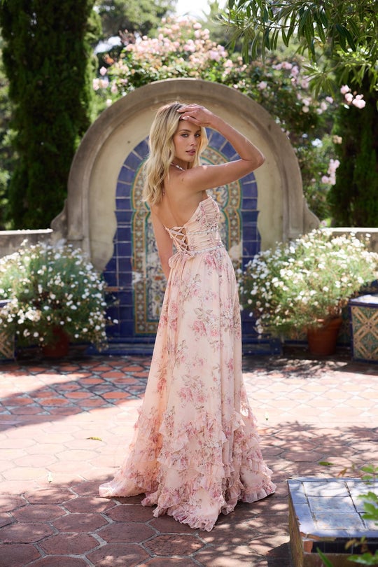 Model wearing the Scarlette peach tapestry gown at three-quarter angle showing skirt volume