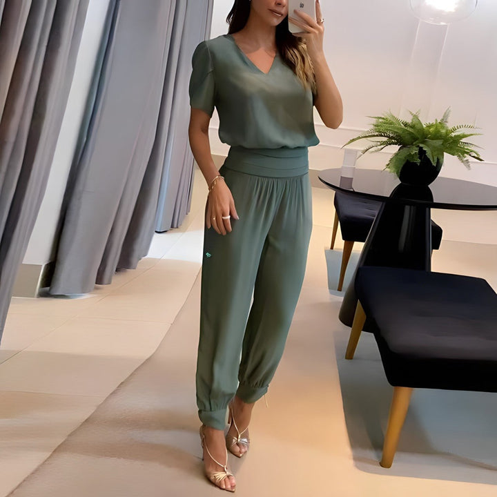 Full-length view of a woman in a green two-piece matching set with a flattering tailored silhouette