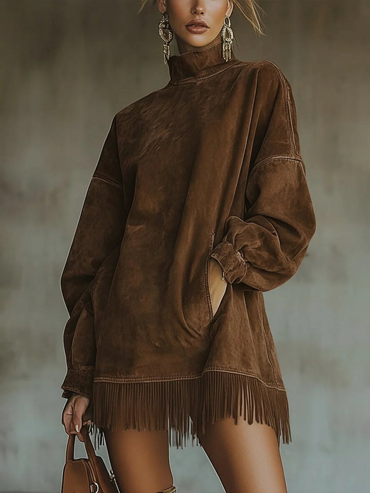 Close-up of fringe hem detail on olive green faux suede turtleneck dress
