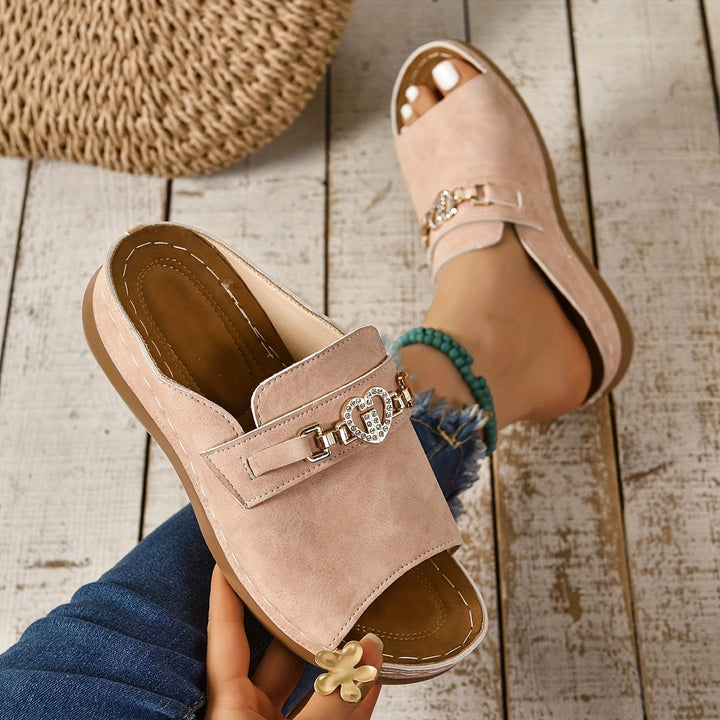 Alexandra flat adjustable sandals in light pink shown from the front on a white background