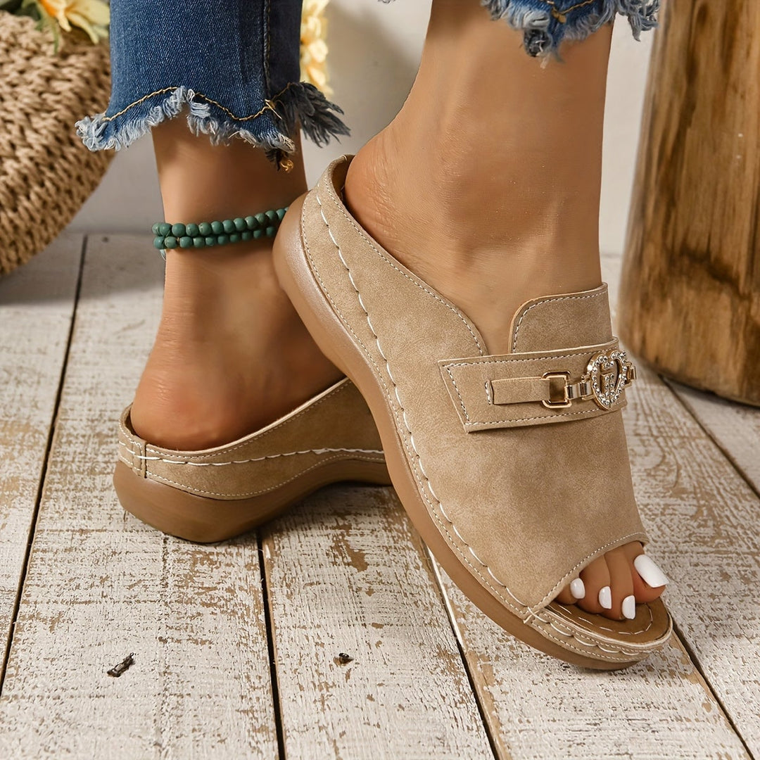 Alexandra light pink sandals styled on a model's feet on a light wood floor