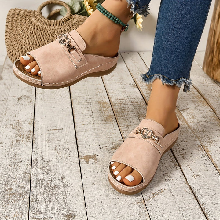 Alexandra sandals in green styled with a flowy white dress on a model