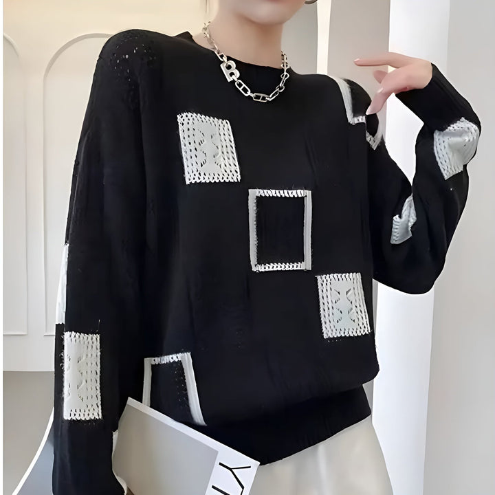 Model wearing the Elegant Squares Sweater in black showcasing the versatile and elegant relaxed fit