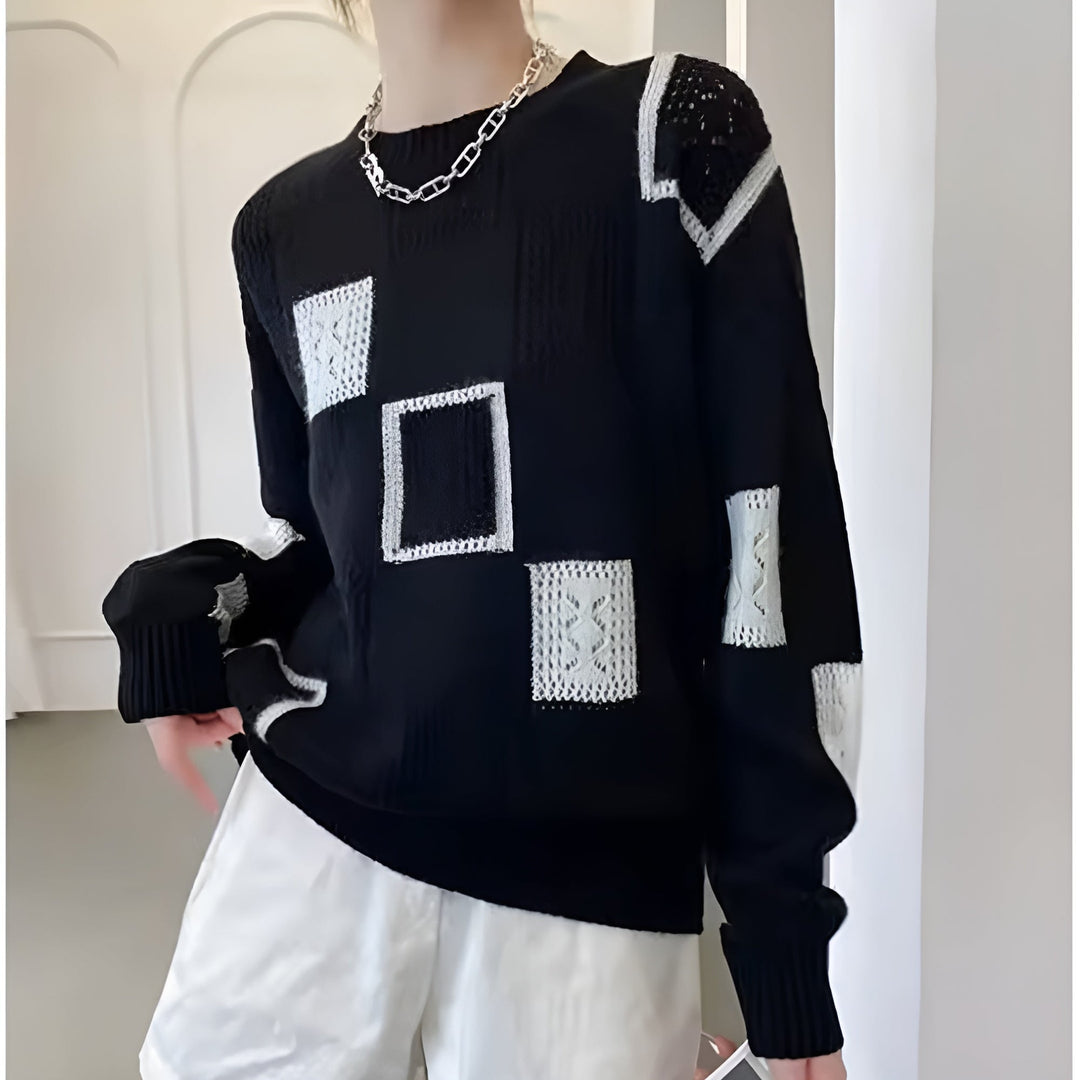 Detail shot of the Elegant Squares Sweater in black displaying the contemporary square pattern and soft knit material