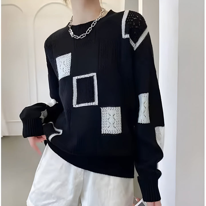 Detail shot of the Elegant Squares Sweater in black displaying the contemporary square pattern and soft knit material