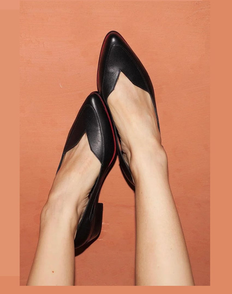 Alinta elegant black high heels shown from a front three-quarter angle, featuring a sleek sculpted silhouette