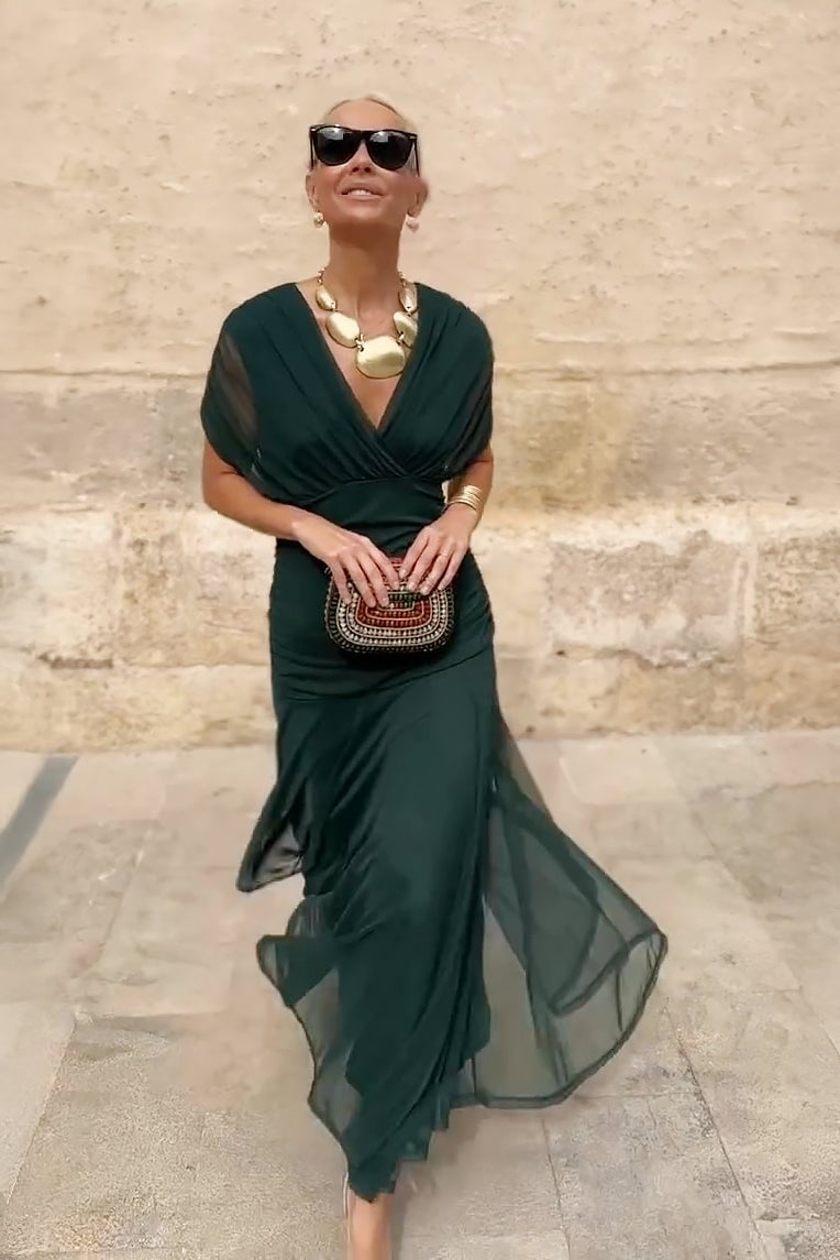 Close-up of the pleated waist detail on a green fantasy maxi dress