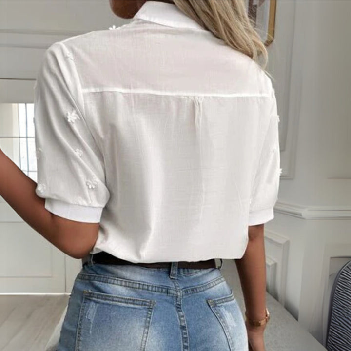 White lace blouse styled with tailored trousers, full-length model view