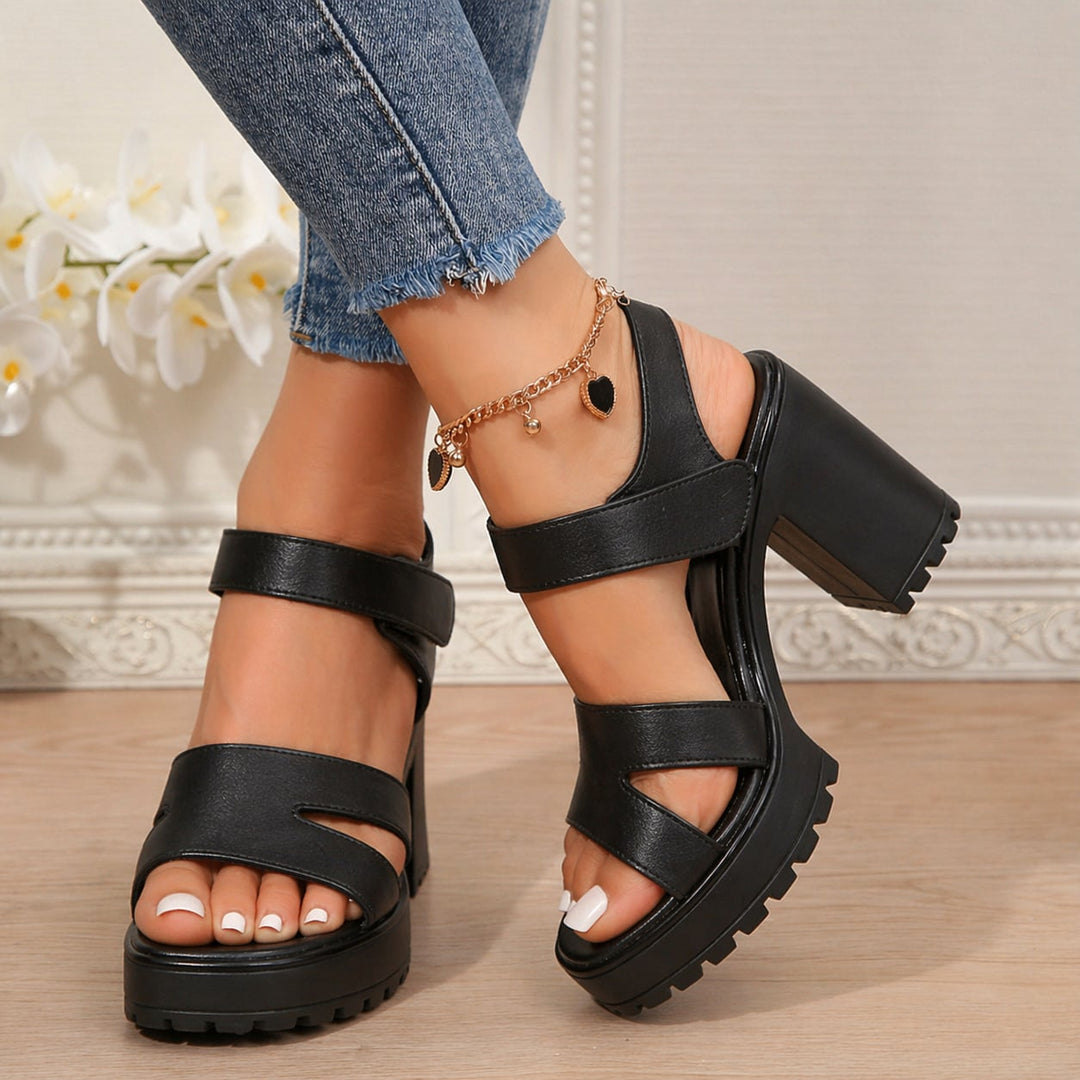 Overhead flat-lay of the Alma black sandal pair on a neutral background