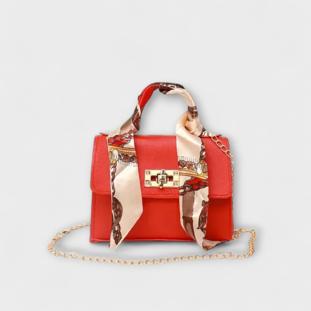 White elegant structured handbag with embossed decorative strap and chain handle