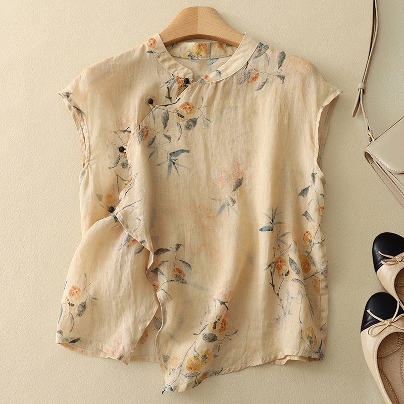 Woman wearing a flowy floral sleeveless top with a mandarin collar and slanted button closure in a dark base print