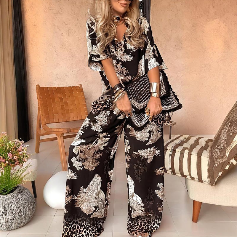 Model wearing a black printed V-neck top and matching long pants set, front view