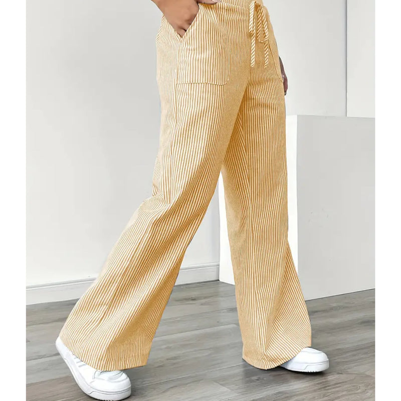 Close-up of vertical stripe pattern on lightweight striped pants in yellow