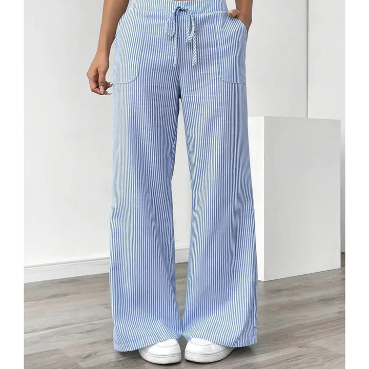 Woman in pink striped pants styled with a white fitted tee, casual everyday look