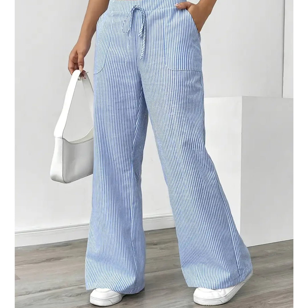 Side view showing functional front pocket detail on pink striped pants