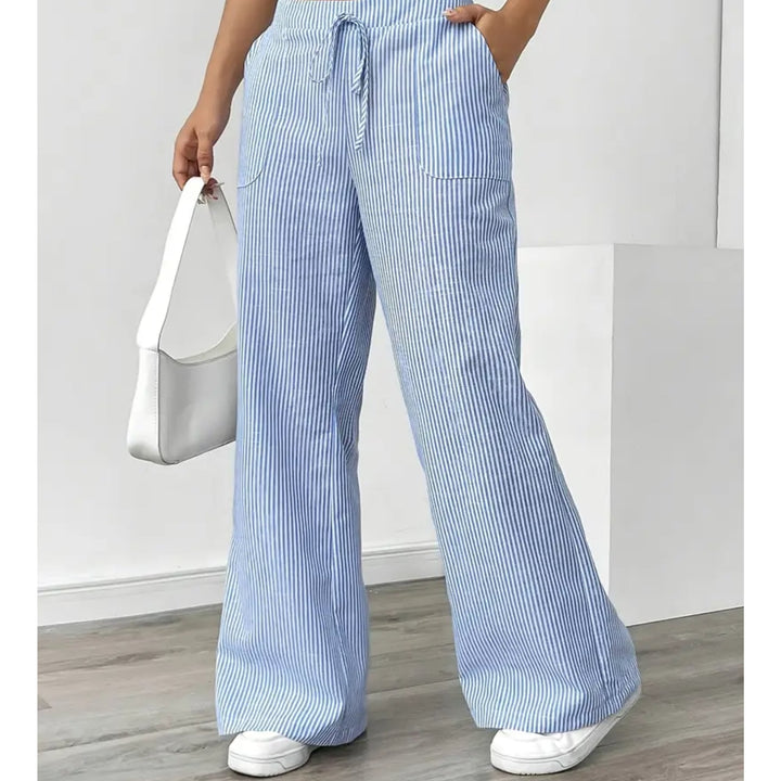 Side view showing functional front pocket detail on pink striped pants