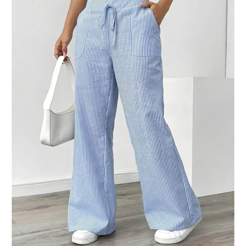 Side view showing functional front pocket detail on pink striped pants