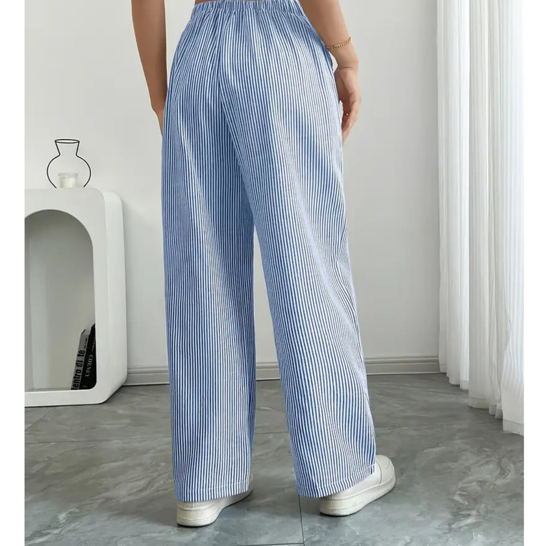 Blue striped pants with drawstring waistband laid flat on a light background
