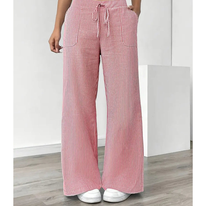 Grey striped pants with pockets styled with a neutral blouse, relaxed outfit