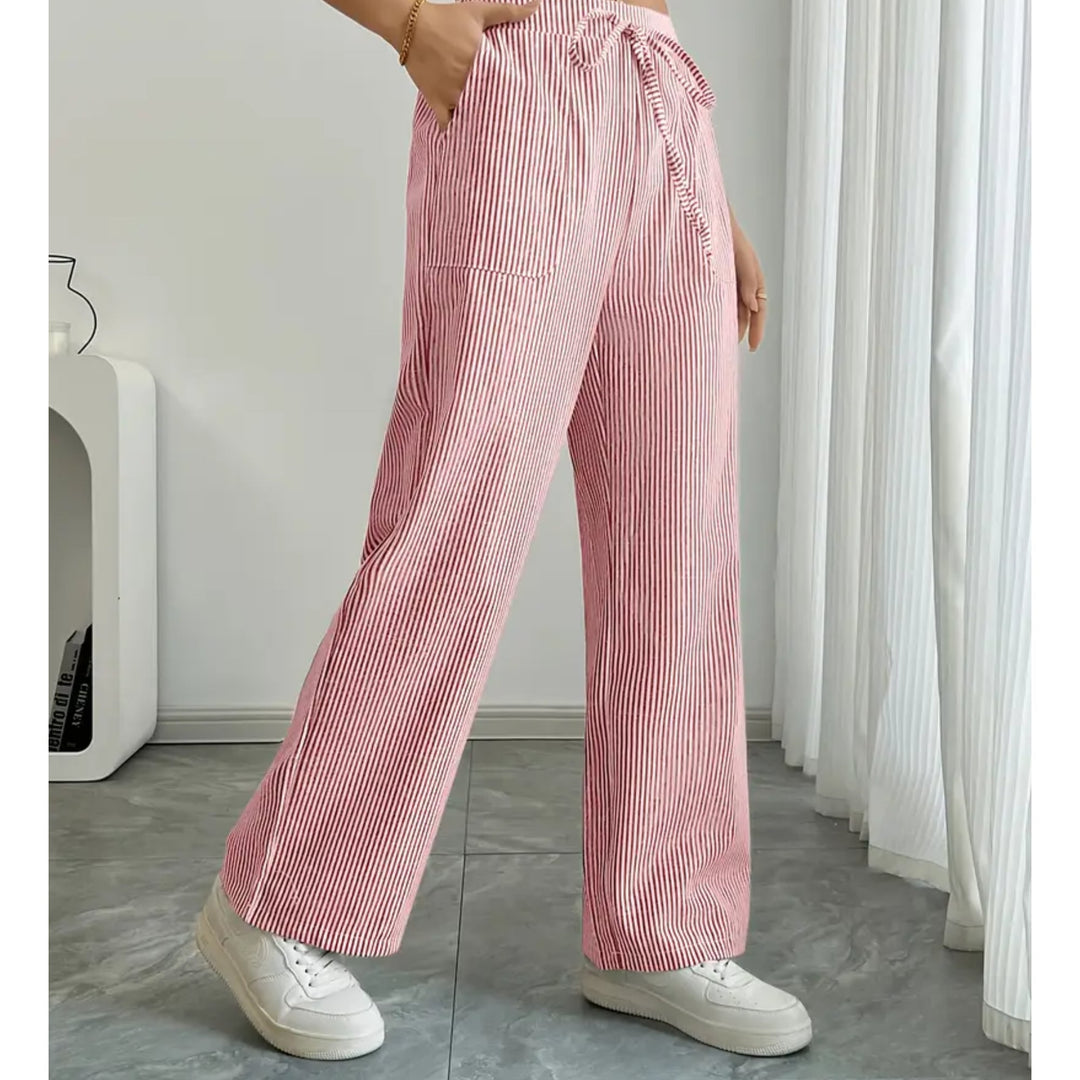 Close-up of adjustable drawstring waistband on grey striped pants
