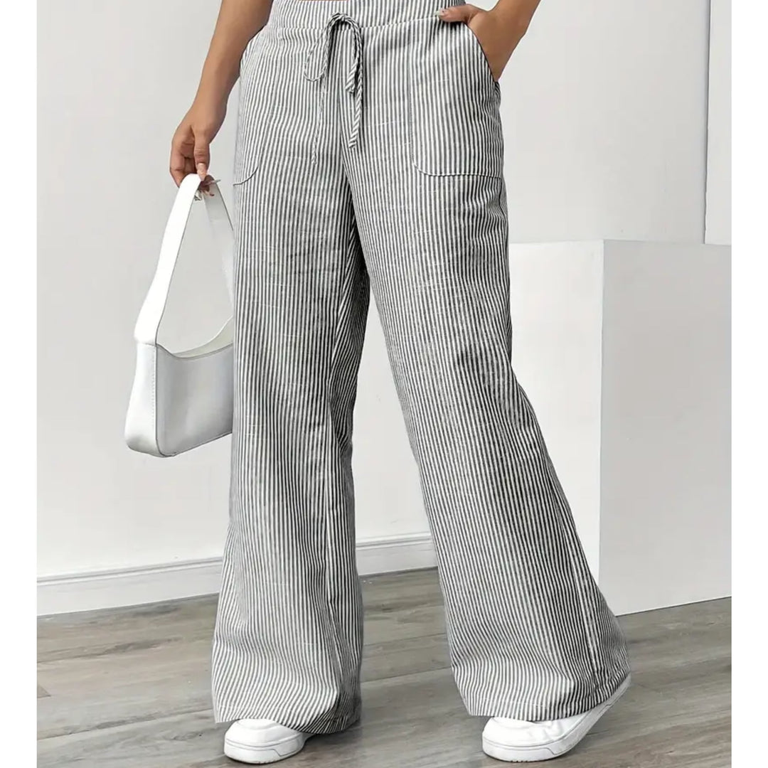Woman in yellow striped pants walking outdoors, showcasing breathable lightweight fabric