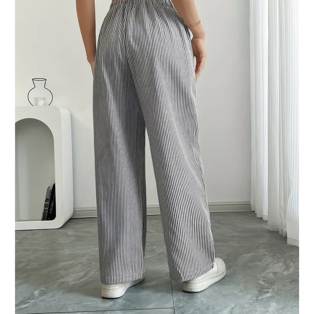 Detail shot of spacious side pocket on striped pants in blue