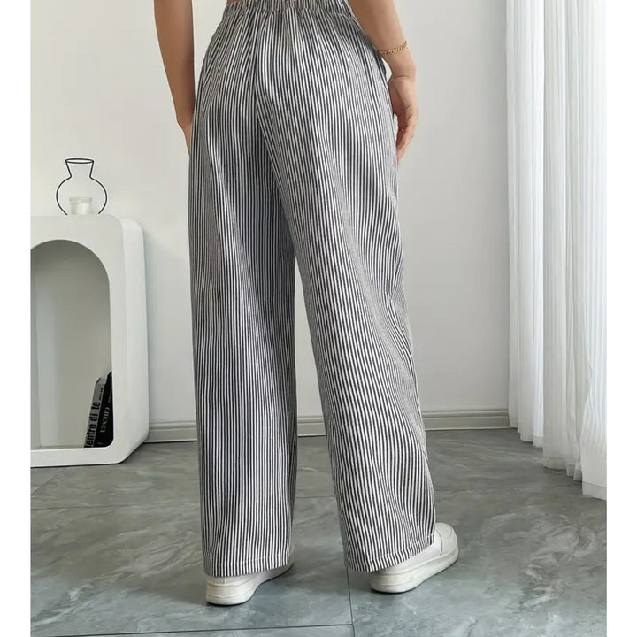 Detail shot of spacious side pocket on striped pants in blue