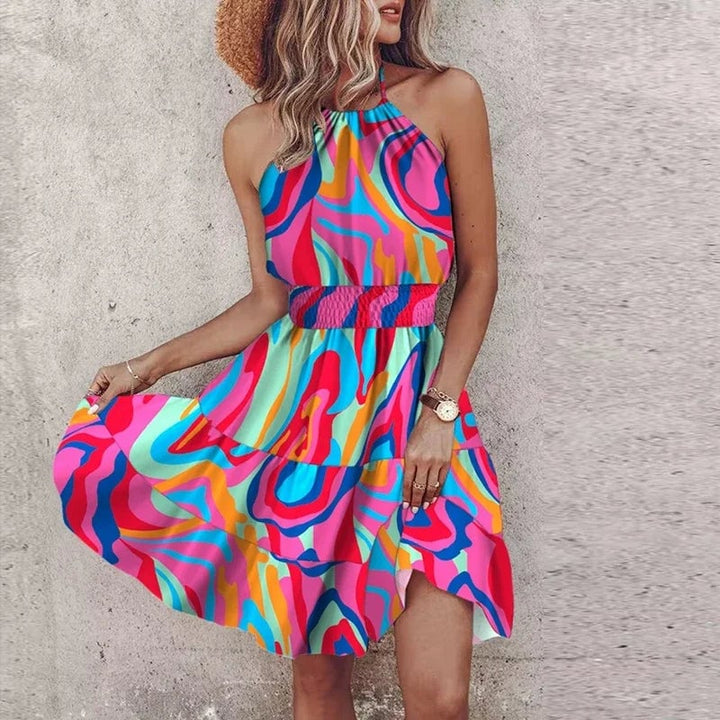 Full-length shot of the Amber draped halter dress in purple against a bright outdoor background