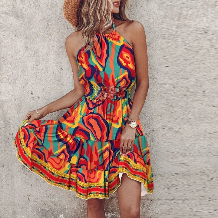 Woman wearing the Amber halter lace dress in orange, smiling and posed in natural light