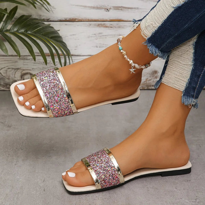 Amber women's rhinestone sandals in purple with glittering embellished straps on a light background