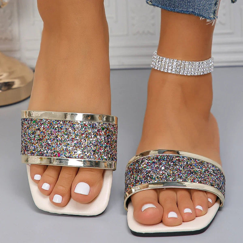 Amber rhinestone sandals in gold shown from a side angle highlighting the cushioned insole