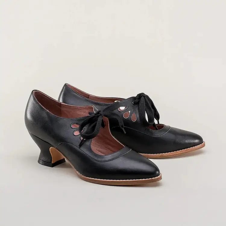 Pair of Amelia vintage heels in black styled with a tea-length floral dress