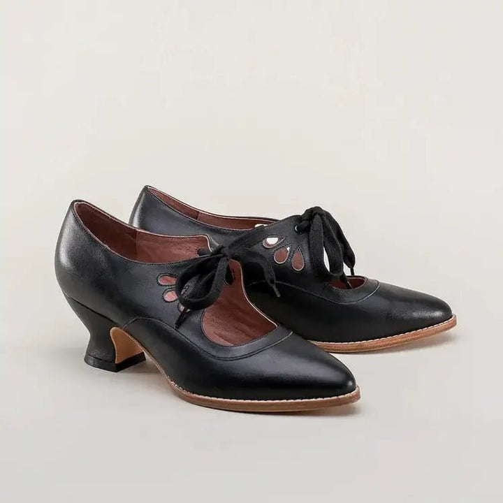 Pair of Amelia vintage heels in black styled with a tea-length floral dress